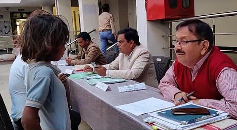 Officials speaking to the child in a public hearing.