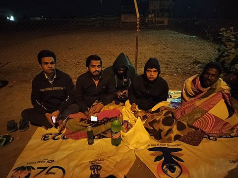 Students sitting outside campus protesting Vivek Mishra's removal from hostel