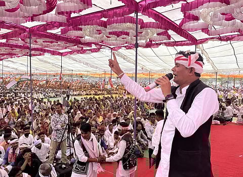 A BAP leader addressing a massive crowd during an election rally.