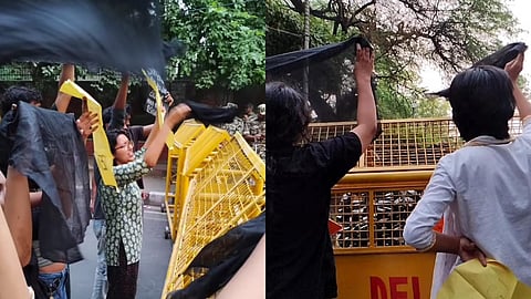 Students protesting with black flags at Delhi University North Campus