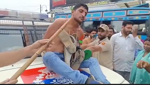 A viral video of the incident shows a large crowd gathered, with some recording and labeling the man a thief.