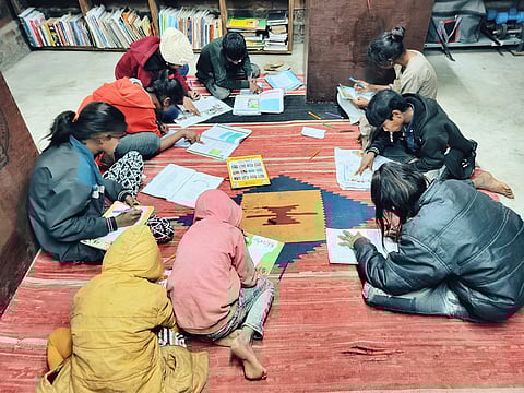 A group of eager children inside the HOWL campus, focusing on foundational education.