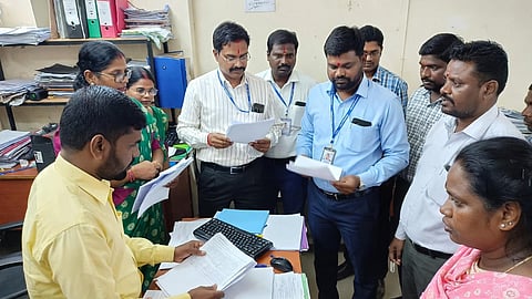 Overburdened teachers remain trapped in non-teaching duties, leaving classrooms understaffed.