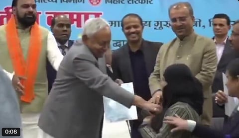 In the footage, Nitish Kumar is seen handing over the appointment letter to the woman, gesturing towards her headscarf, questioning her about it, and asking her to remove it. Moments later, he appears to pull it down himself.