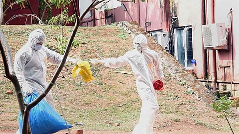 Health officials clear waste from isolation ward of Ernakulam Medical College during the Nipah outbreak in 2021