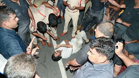 Jana Sena Pawan Kalyan lies on the road in protest against AP police in Anumanchipalli, Andhra Pradesh.