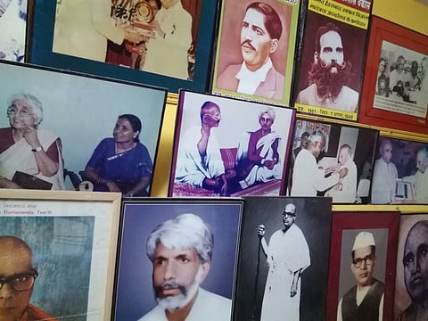 A collection of photos of important leaders on the wall of Vidhyadhar Guruji’s house in Gulbarga, 2017