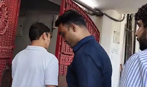 Officials sealing the NewsClick office in Delhi
