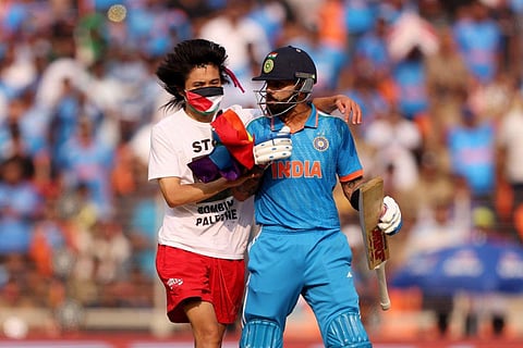 Pro Palestine protestor Johnson Wen with Virat Kohli on the pitch