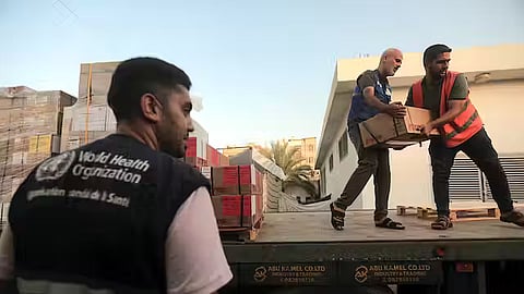 People unload boxes of medicine from a truck at the Nasser Medical Complex in Khan Younis, the southern Gaza Strip, on Oct. 23, 2023.