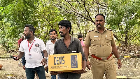 Masood, the father of the deceased baby carrying the corpse in a cardboard box