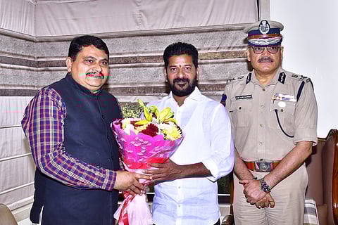 Additional DG CID Mahesh Bhagwat (left) and Telangana DGP Anjani Kumar (right) with Revanth Reddy