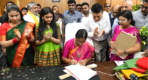 Minister Konda Surekha signing the order to double ex-gratia