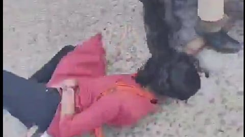 Screengrab from video showing the police dragging the girl's hair