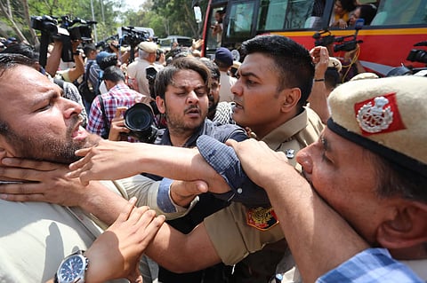 A policeman grabs India Today’s Arun Thakur.