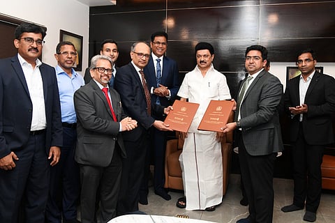 Tamil Nadu CM MK Stalin along with TATA Motors' personnel with MoU.