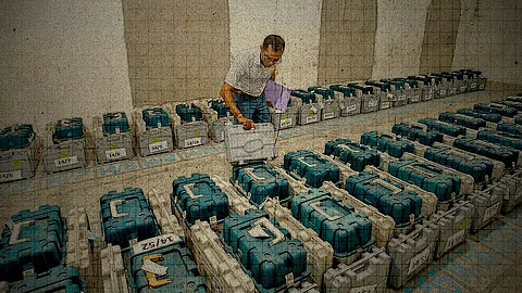 A polling official checks Electronic Voting Machines (EVM)