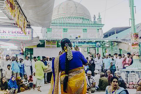 A member of a Kinner group performing at the main shrine of the Haji Malang Dargah seeking alms