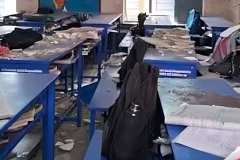 Cement plasters from the roof having collapsed on the desks of students