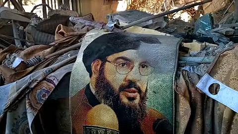 A picture of the secretary-general of Hezbollah Hassan Nasrallah is seen among the rubble following an Israeli air strike.