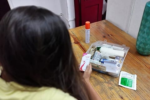 Woman holding an iPill packet