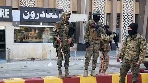 Anti-Assad fighters stationed at the airport in Aleppo on Dec. 2, 2024.
