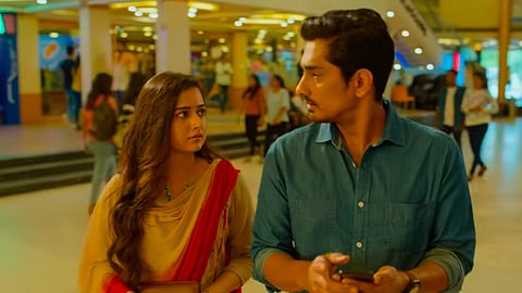 Ashika, Siddharth in a scene from Miss You, seen speaking to each other in a mall.