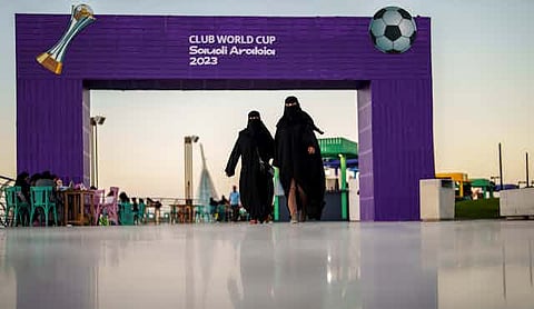 Women walk in front of a fan zone during the Soccer Club World Cup in Saudi Arabia, 2023. Manu Fernandez/AP