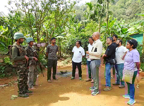 Members of the fact-finding team speak with Anti-Naxal Force personnel in Peetabailu in Udupi district.