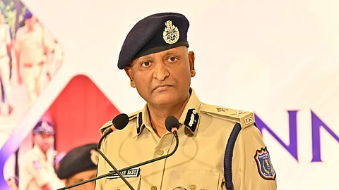 Rachakonda Commissioner of Police G Sudheer Babu in his police uniform standing in front of a mic