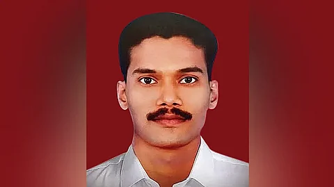 DYFI activist Rijith against a backdrop of red color
