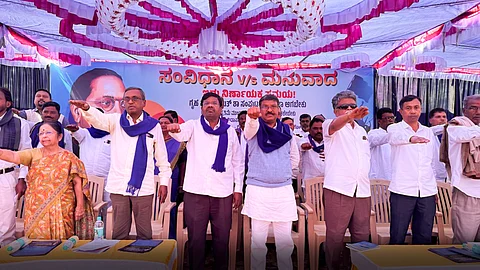 Dalit leaders hold out their arms while reciting the Preamble of the Constitution during a protest in Bengaluru against Union Home Minister Amit Shah's remarks about BR Ambedkar. (From left) Indira Krishnappa, Indudhara Honnapura, Guruprasad Keragodu, and Mavalli Shankar.