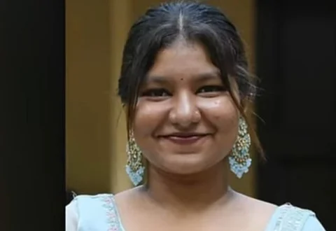 Anamika smiles warmly, dressed in a light blue outfit with matching earrings