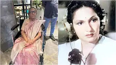 Krishnaveni, in her old age, sitting in a wheelchair wearing a light pink saree is shown on the left side of the image. On the right side, there is a younger version of the same woman in a vintage-style film still, wearing a white outfit with a headset, holding a microphone, and looking serious.