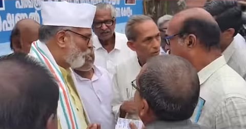 image of Tushar Gandhi and protesters.