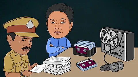 A cartoon shows a police officer sitting at a table examining documents. A character resembling Kiran Bedi stands with arms crossed, facing the scene. Tapes and headphones are on the table, with a stack of tapes nearby.