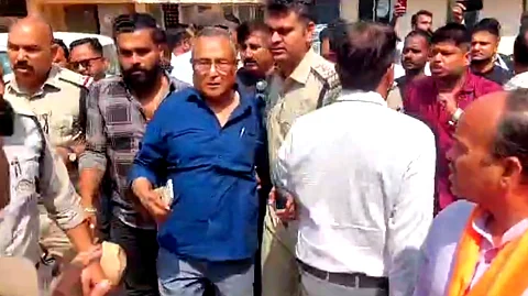 Police rescue priests as they are attacked by a mob inside the station