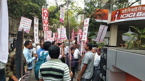 Image of ICICI employees gathered outside the bank's Kolkata branch bearing placards