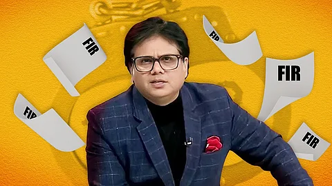 DD News anchor Ashok Shrivastav's headshot where he faces the camera admist his primetime news show.