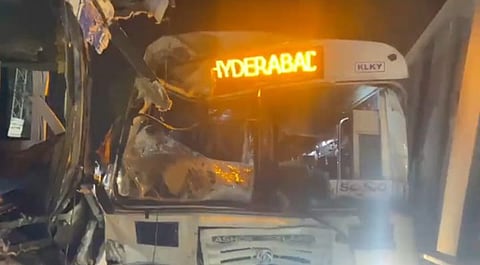 Damaged front of a TGSRTC bus with "Hyderabad" lit up on the display, following a crash on the Srisailam highway at night.