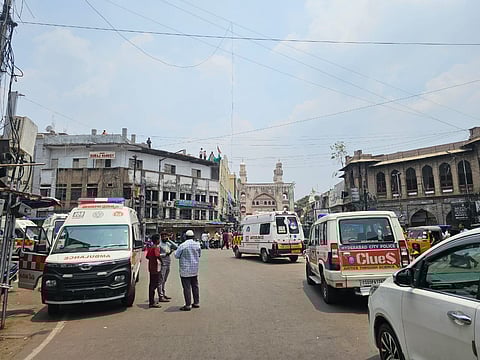 Ambulances parked in the area outside the burned building