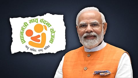 Prime Minister Narendra Modi stands beside the Pradhan Mantri Matru Vandana Yojana logo, promoting maternal and child health