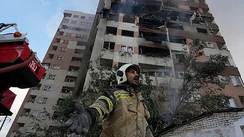 A firefighter at the scene of an explosion at a residential compound in northern Tehran that was believed to have been struck by Israel. Vahid Salemi/AP