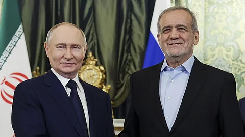 Russian President Vladimir Putin, left, and Iranian President Masoud Pezeshkian pose for a photo during their meeting at the Kremlin on January 17, 2025.
