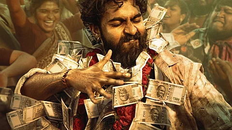 Yuva Rajkumar in a poster of the film Ekka. He is wearing garlands of currency notes and dancing. A celebratory crowd behind him