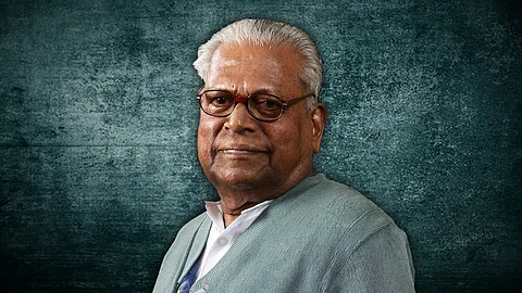 A side profile of VS Achuthananthan in a white shirt and greyish green sweater. A green background