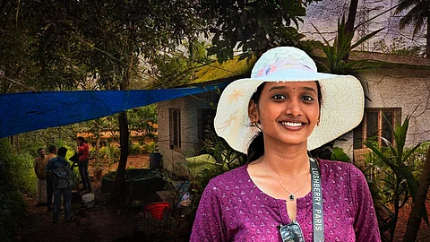 Smiling young woman wearing a white sun hat and purple top, identified as Sona Eldhose, with a rural Kerala home and visitors in the background.