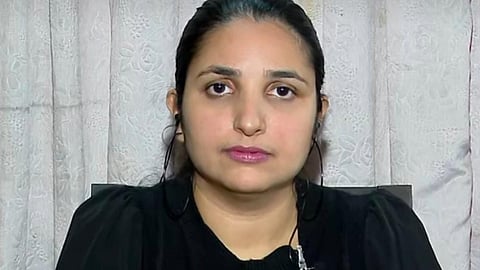 Picture of Rini Ann George dressed on black, facing the camera