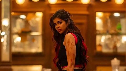Kalyani Priyadarshan in a still from Lokah, holding a dagger in her hand.