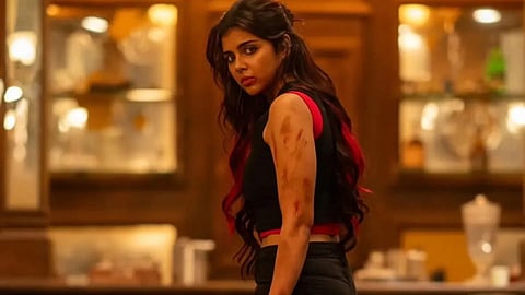 Kalyani Priyadarshan in a still from Lokah, holding a dagger in her hand.